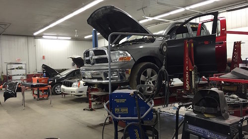 Hilltop Collision Inside Shop with Truck on Lift